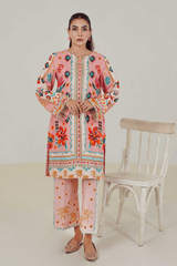 Woman wearing a colorful outfit with a white chair in the background