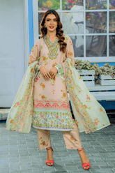 Woman in a light pink and green traditional outfit standing on a street.