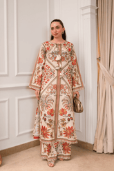 Woman wearing a floral outfit in an elegant interior setting