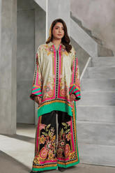 Woman wearing a colorful outfit standing on a staircase.