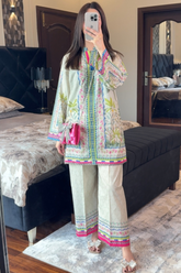 Person wearing a colorful traditional outfit in a bedroom setting