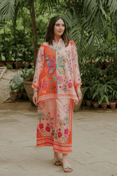 Woman wearing a colorful outfit in an outdoor setting with plants.