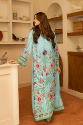 Woman wearing a light blue embroidered dress in a kitchen setting