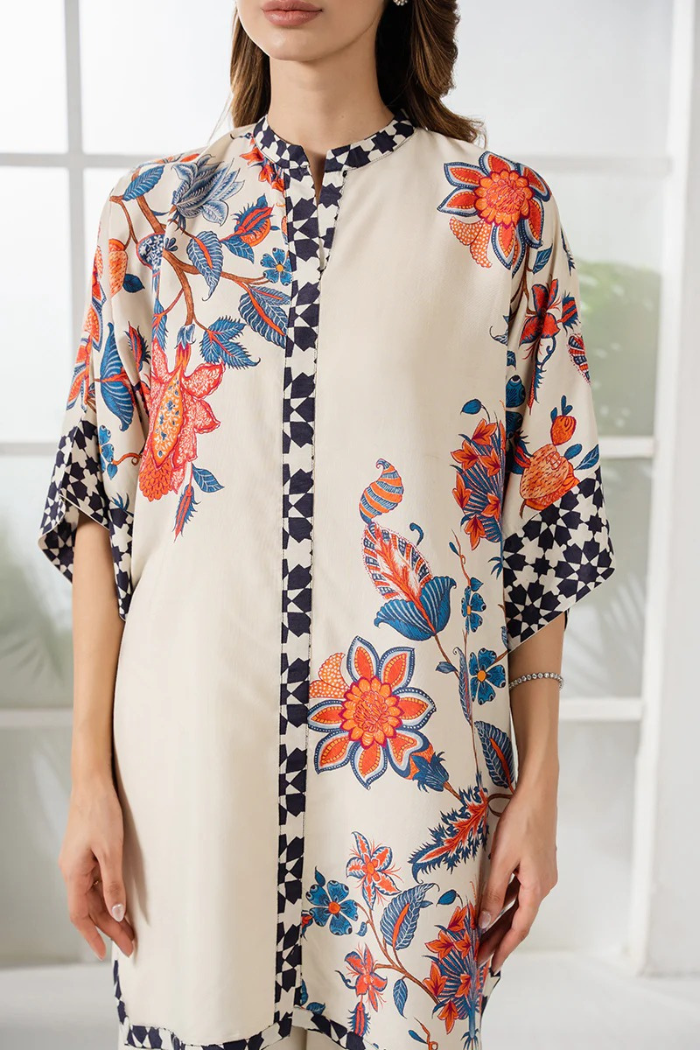 Woman wearing a floral kimono-style garment with a neutral background