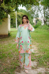 Front view of pastel green floral muslin kurta set with dupatta.