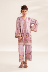 Woman wearing a pink printed outfit on a white background