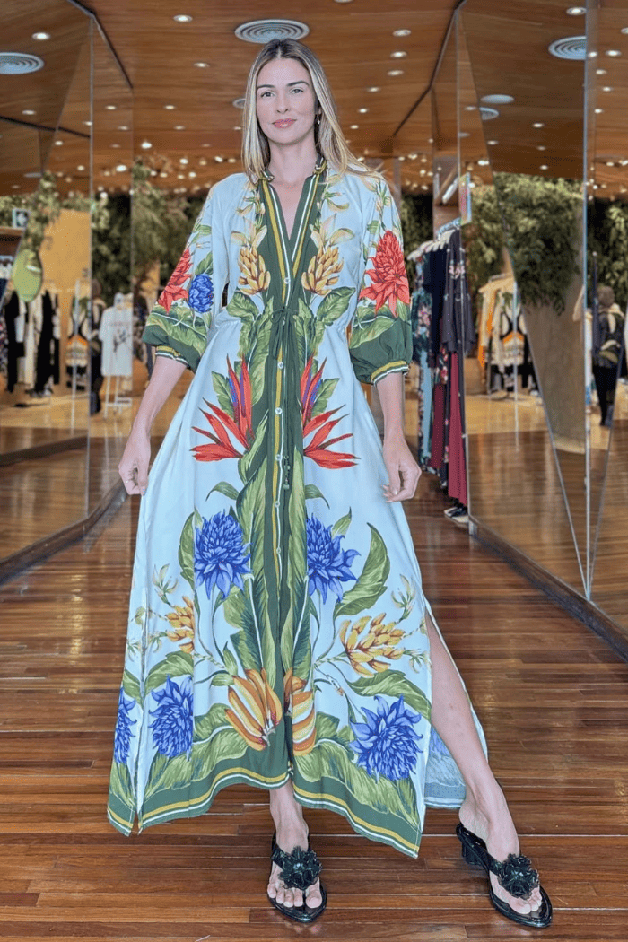 Woman wearing a colorful floral dress in a shopping mall setting
