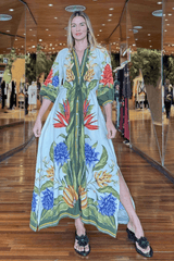 Woman wearing a colorful floral dress in a shopping mall setting
