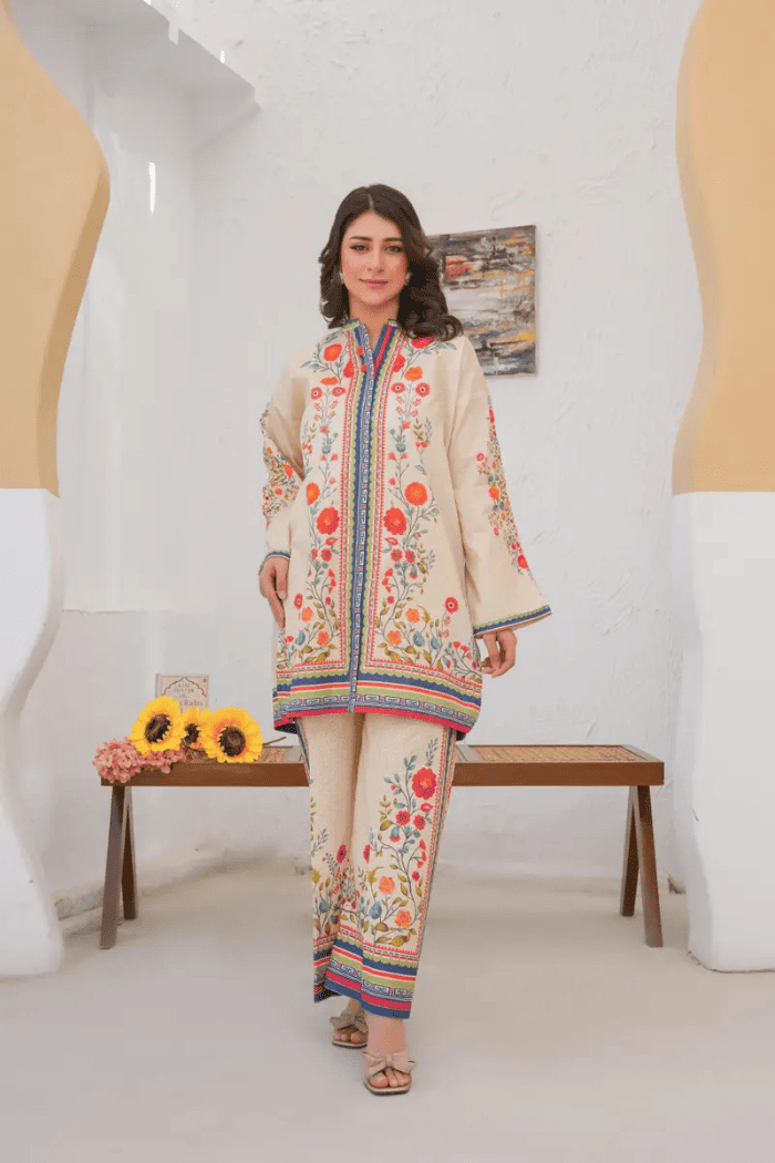 Woman in a floral outfit standing in a modern interior setting