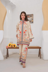 Woman in a floral outfit standing in a modern interior setting