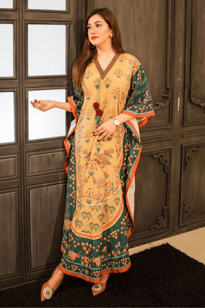 Woman wearing a traditional outfit with a floral design in a room with wooden paneling.