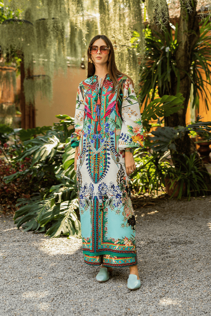 Woman in a colorful dress standing in a garden setting