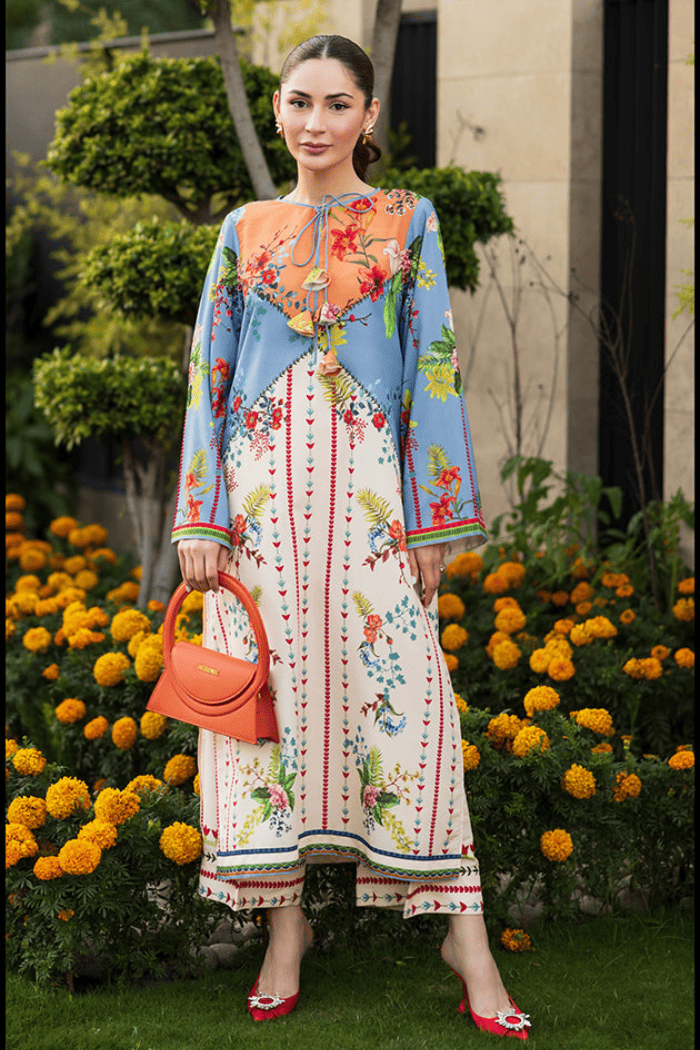 Woman in a colorful dress standing in front of flowers