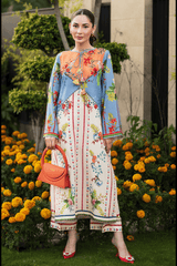 Woman in a colorful dress standing in front of flowers