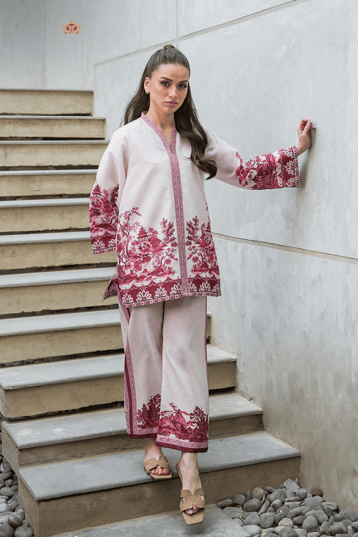 Woman in a traditional outfit with red standing on stone steps.