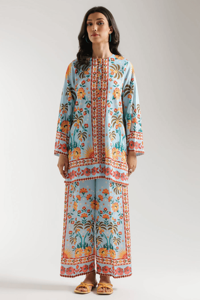 Woman wearing a colorful floral dress on a white background