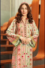 Woman wearing a floral embroidered outfit sitting on a wooden chair.