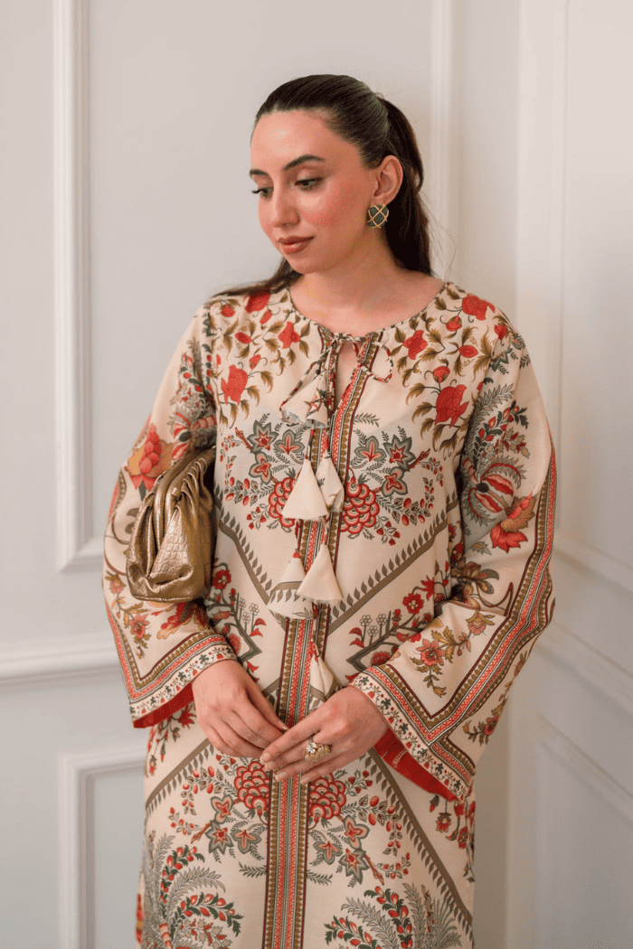 Woman wearing a patterned dress with a neutral background
