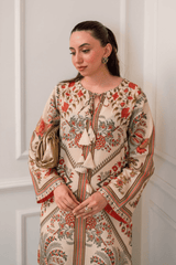 Woman wearing a patterned dress with a neutral background