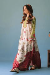 Woman wearing a floral and patterned traditional outfit against a blue background