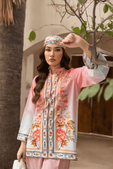 Woman wearing a floral dress and headscarf in an outdoor setting