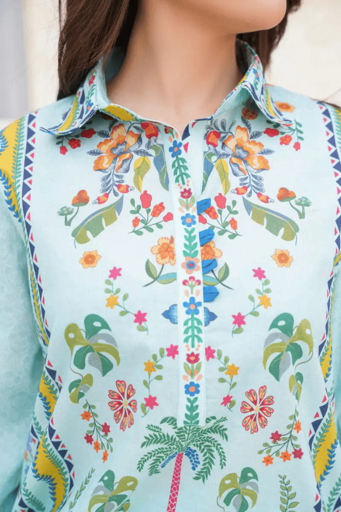 Colorful shirt with floral and geometric patterns on a light blue background