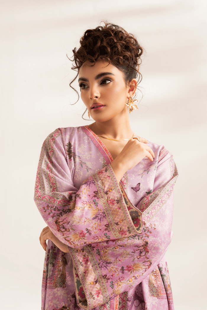 Woman wearing a pink floral dress against a white background