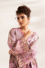 Woman wearing a pink floral dress against a white background