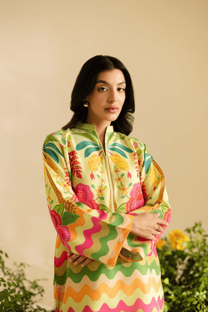Woman wearing a colorful patterned dress against a beige background