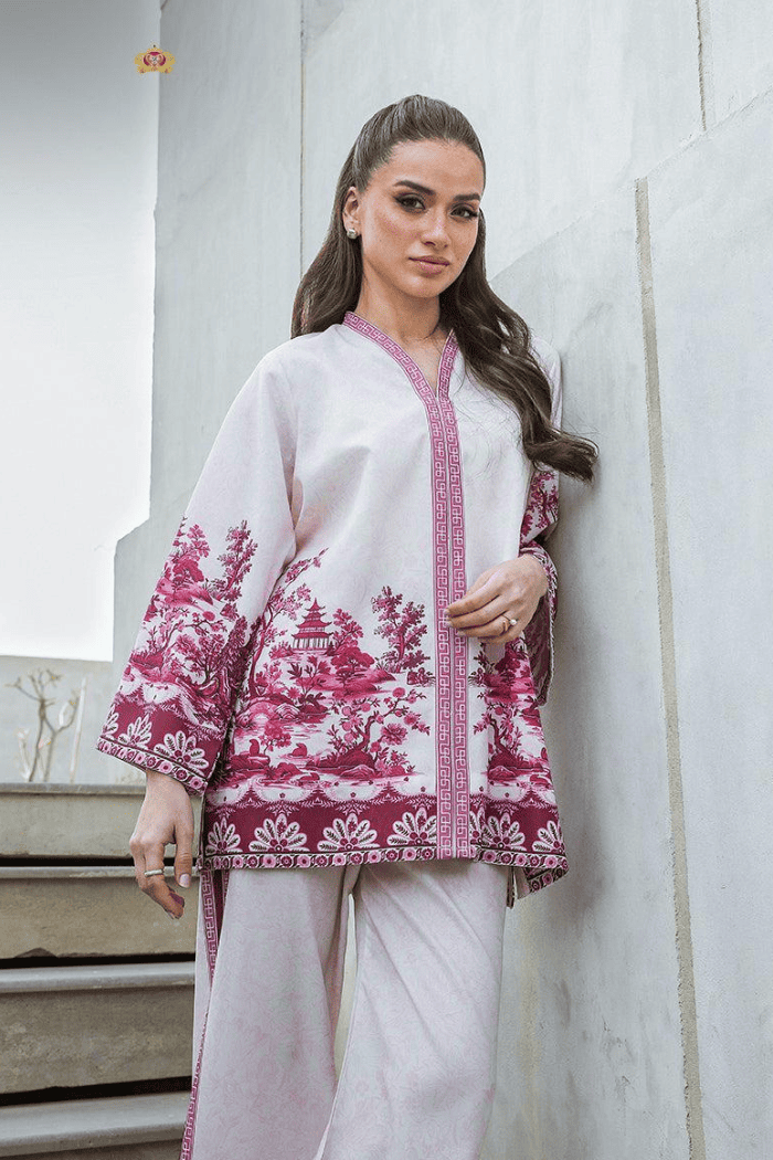 Woman wearing a white outfit with pink floral  against a light gray background