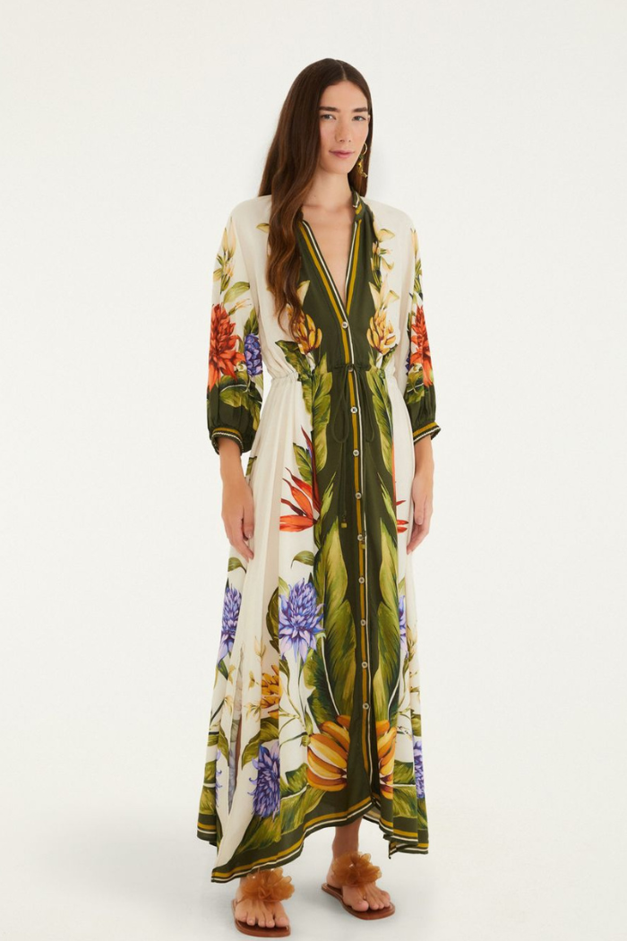 Woman wearing a long floral dress on a white background
