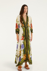 Woman wearing a long floral dress on a white background