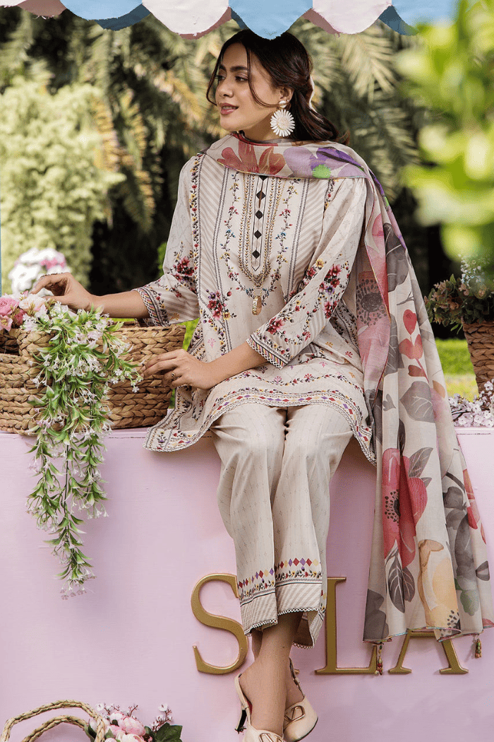 Woman in traditional outfit with floral patterns sitting outdoors