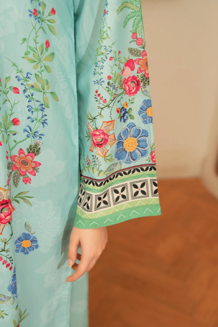 Light blue fabric with colorful floral embroidery on a blurred background