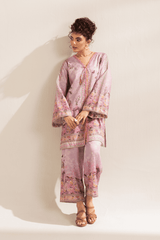 Woman wearing a pink floral outfit against a white background