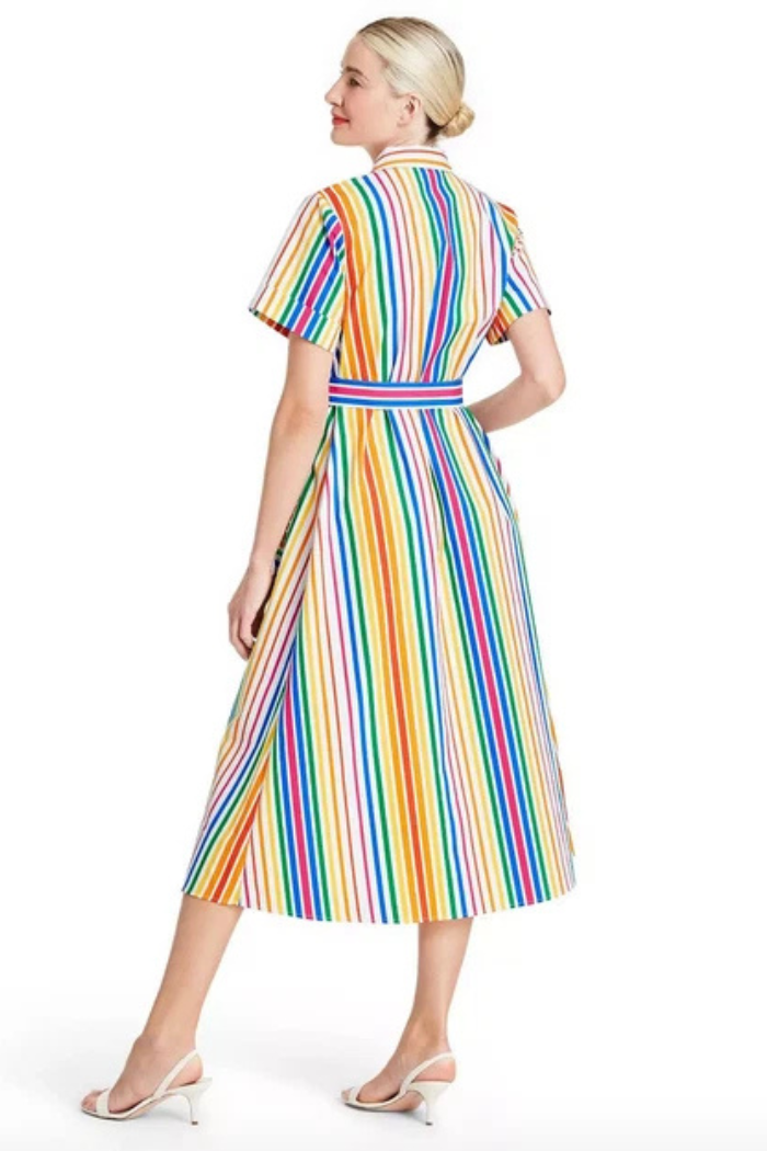 Woman wearing a rainbow striped dress on a white background