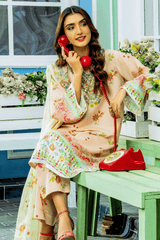 Woman in a floral dress sitting on a green bench with a red phone