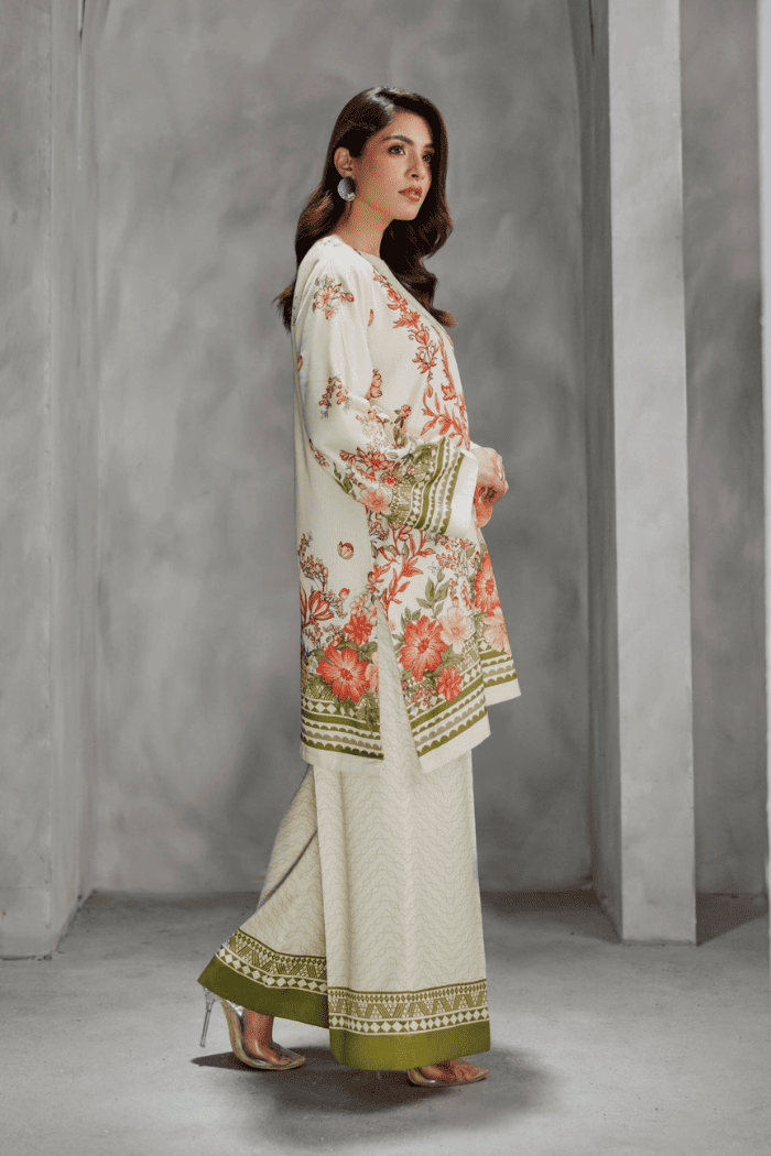 Woman wearing a floral outfit with a plain background