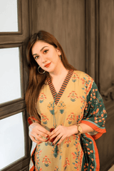 Woman wearing a floral dress standing indoors near a window.