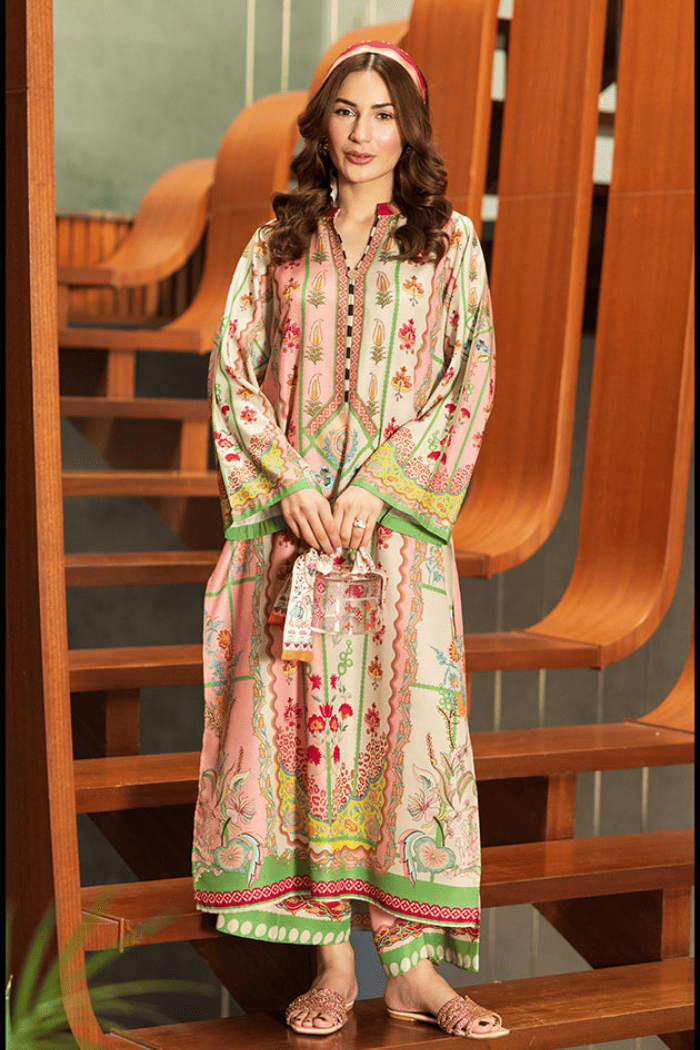Woman wearing a colorful traditional outfit sitting on a wooden staircase.
