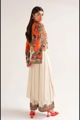 Woman wearing a colorful traditional outfit with a white background