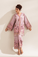 Woman wearing a pink floral outfit against a white background