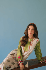 Woman wearing a traditional outfit with floral patterns against a blue background
