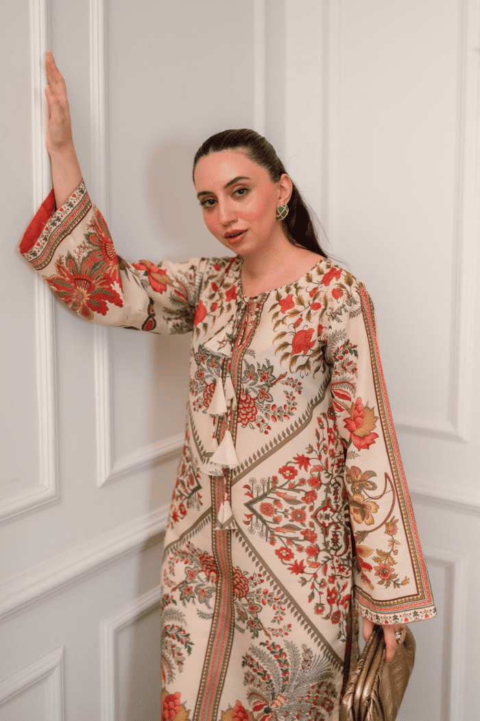 Woman wearing a floral dress against a white paneled wall