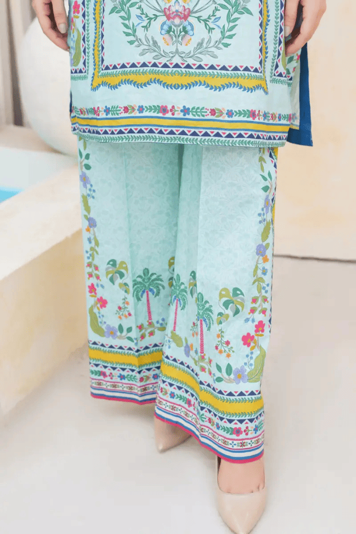 Light blue outfit with colorful floral and palm tree patterns on a white background