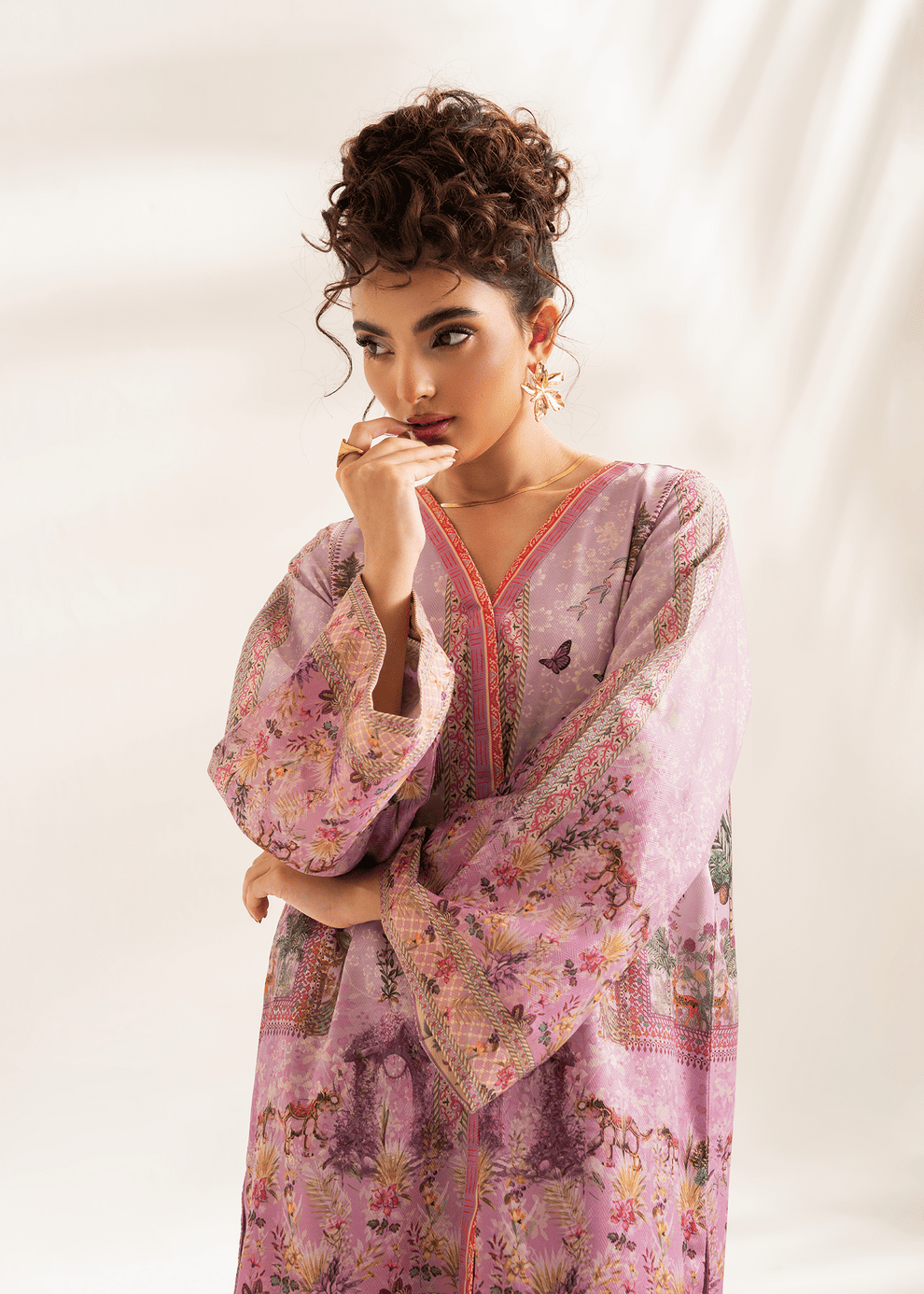 Woman wearing a pink floral dress with a white background