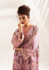 Woman wearing a pink floral dress with a white background
